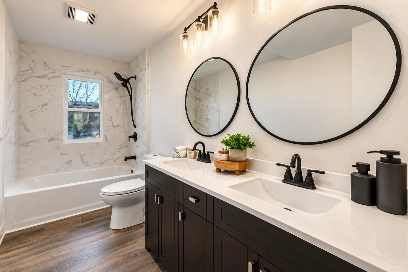 Double vanity bathroom with marble-look tub surround and black fixtures