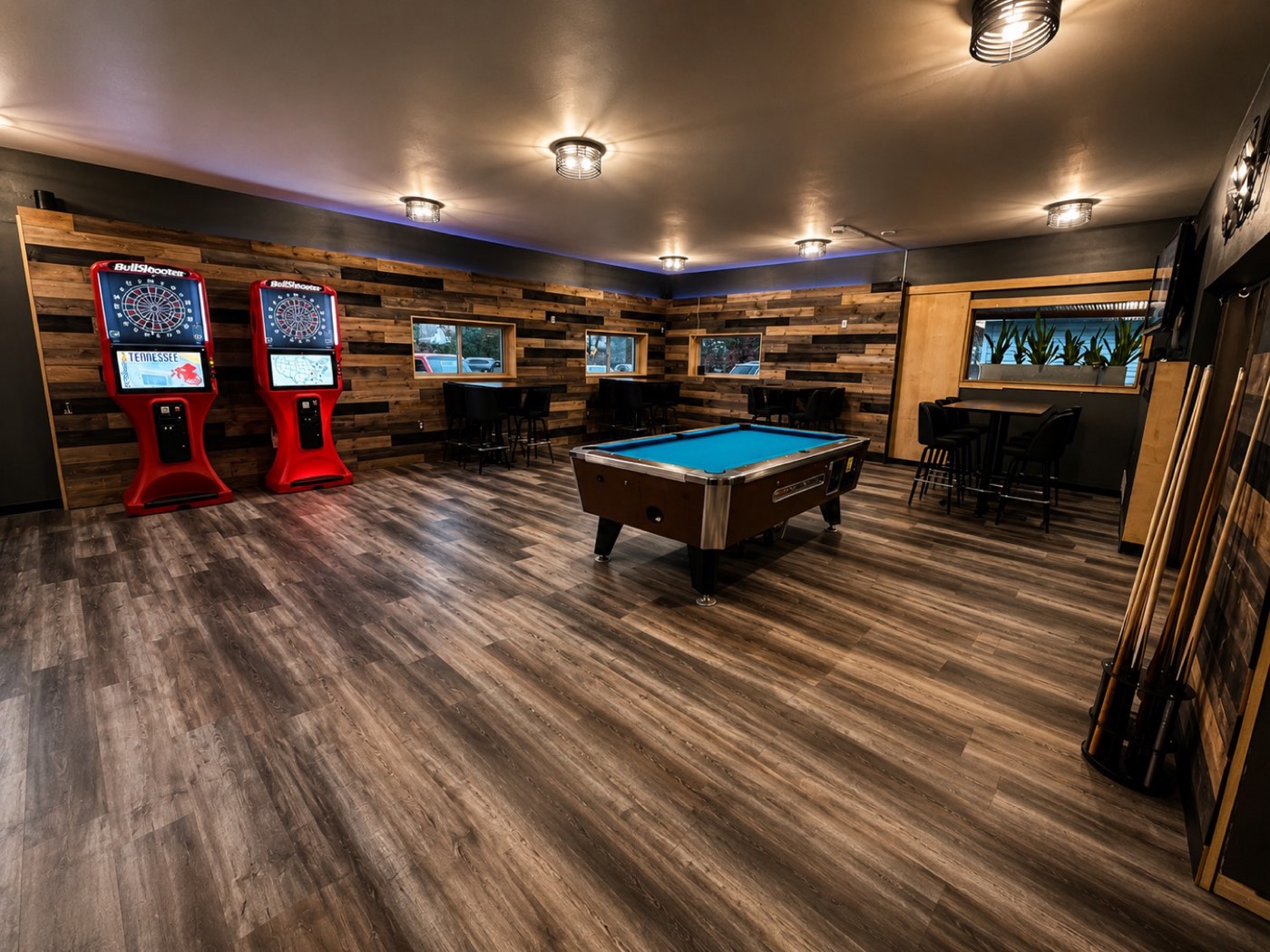 Commercial game room with reclaimed wood accent walls and vinyl plank flooring