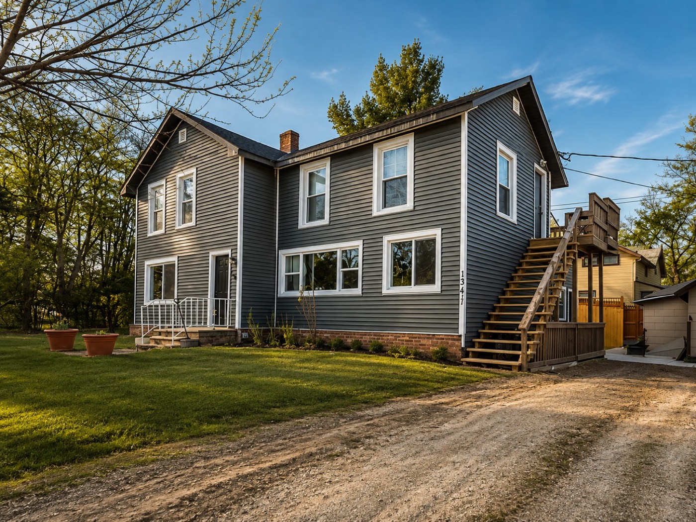 Two-story home with new charcoal siding and white trim